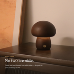 Cute wooden mushroom bedside lamp beside a book and coffee cup creating cozy bedroom ambiance
