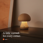 Mushroom night light casting a warm amber glow in a dimly lit bedroom showcasing sleep-friendly lighting
